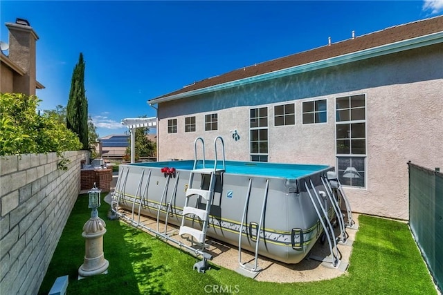 back of property featuring a fenced backyard, stucco siding, and a yard