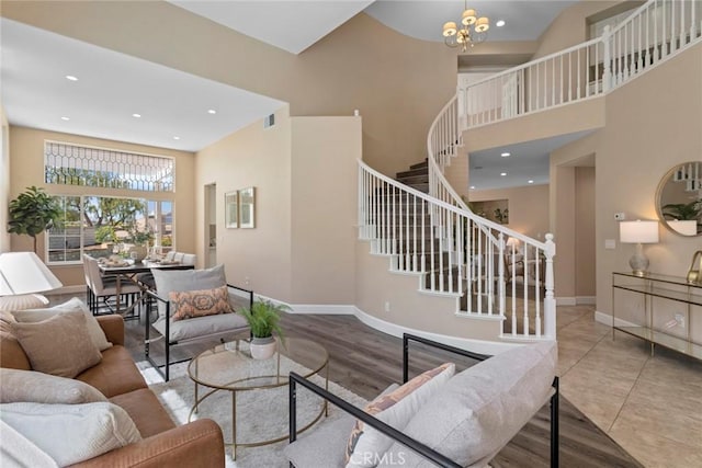 living room featuring visible vents, recessed lighting, stairs, and a towering ceiling