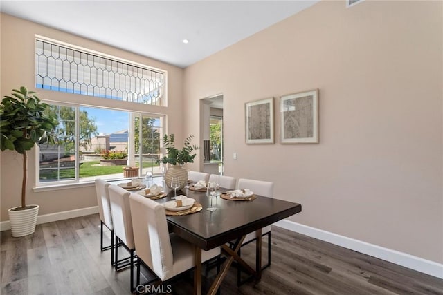 dining space featuring recessed lighting, baseboards, and dark wood-style floors