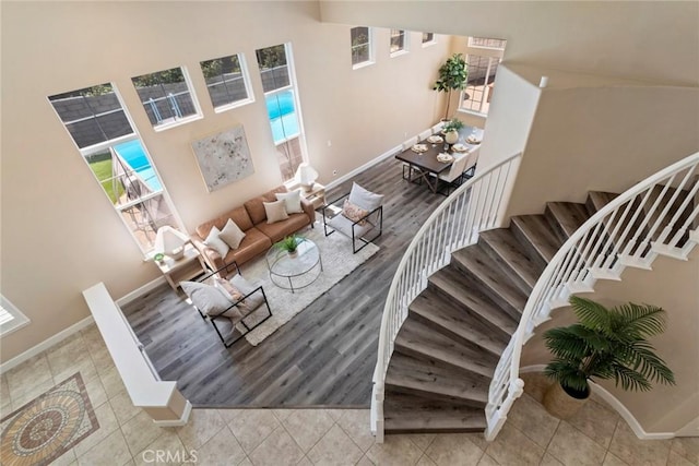 25925 Clifton Pl, Stevenson Ranch, CA 91381 - stairway featuring a towering ceiling, baseboards, and tile patterned flooring
