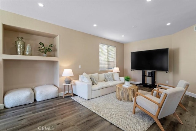 living area featuring recessed lighting, baseboards, and wood finished floors