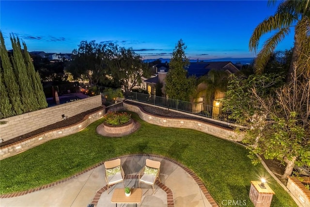 view of yard featuring fence and a patio
