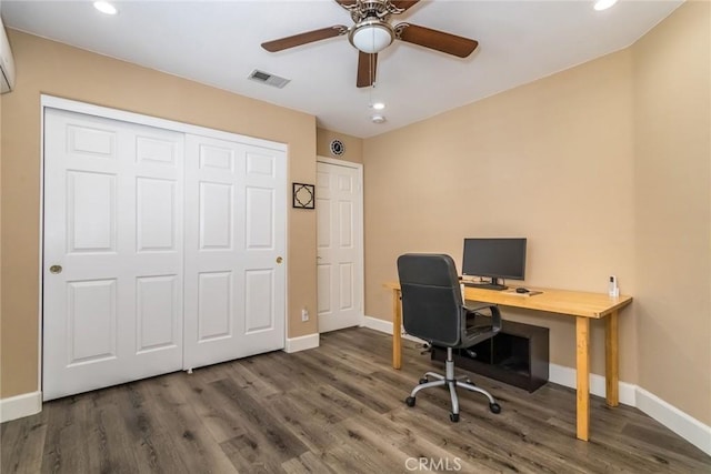 office space featuring visible vents, baseboards, ceiling fan, and wood finished floors