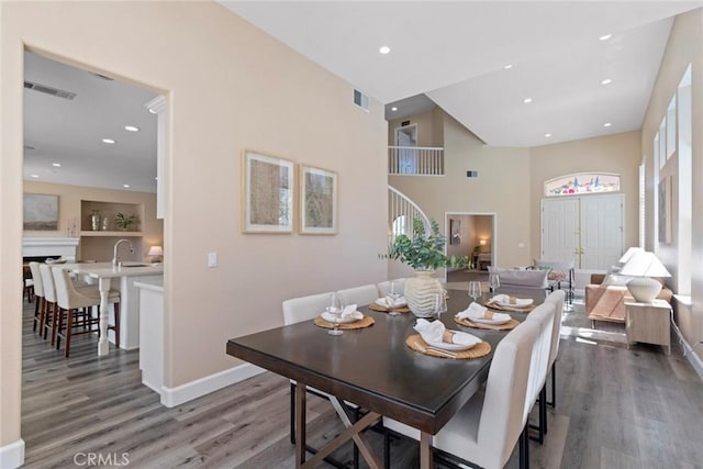 dining room featuring baseboards, wood finished floors, and visible vents