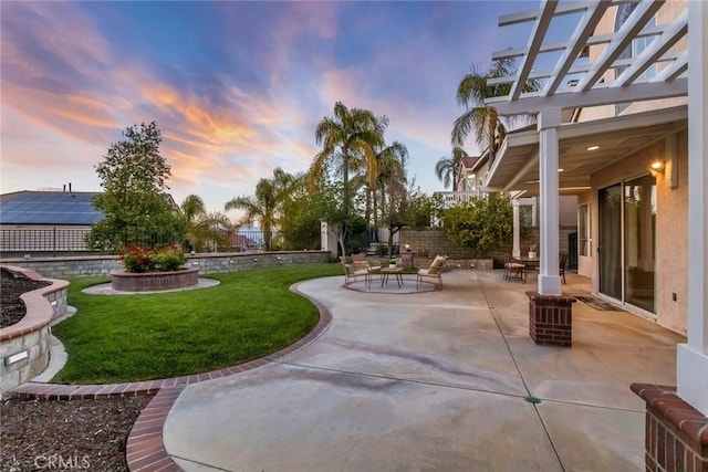 yard at dusk featuring a patio, a fenced backyard, and a pergola