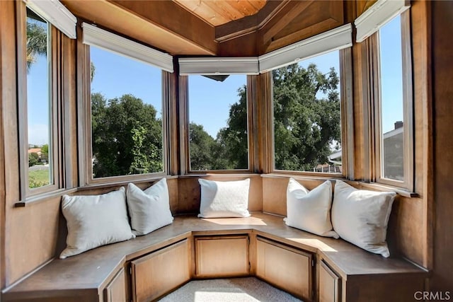 unfurnished sunroom with wood ceiling and plenty of natural light
