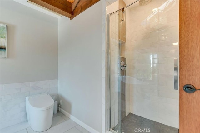 bathroom with toilet, tile patterned floors, and a shower stall