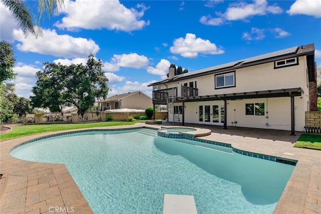 view of swimming pool featuring a deck, a patio, french doors, stairs, and a pool with connected hot tub