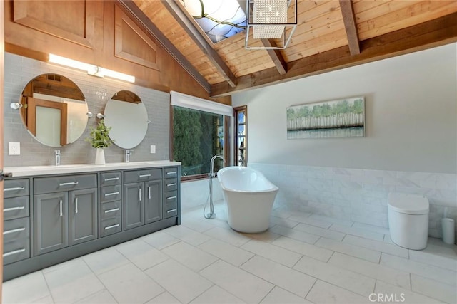 full bathroom featuring a freestanding bath, double vanity, tile walls, wooden ceiling, and beamed ceiling
