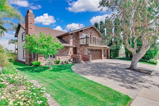 view of front of house featuring a garage, a balcony, a chimney, brick siding, and driveway