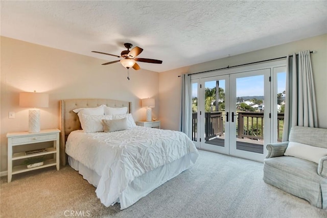 bedroom with carpet flooring, a textured ceiling, access to exterior, and french doors