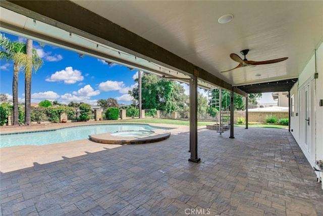 view of swimming pool featuring a fenced backyard, ceiling fan, a pool with connected hot tub, and a patio area