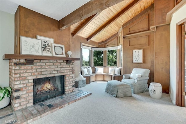 sitting room featuring carpet, wood ceiling, lofted ceiling with beams, and a fireplace