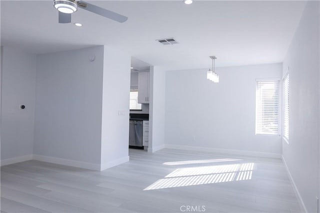 spare room featuring a ceiling fan, visible vents, light wood-style flooring, and recessed lighting