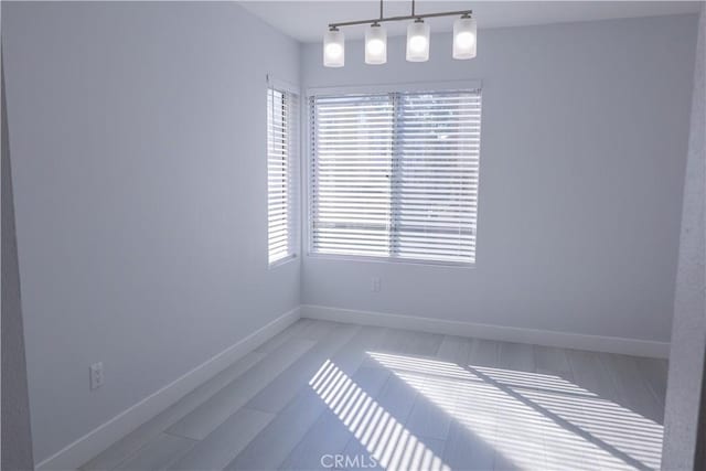 unfurnished dining area with baseboards