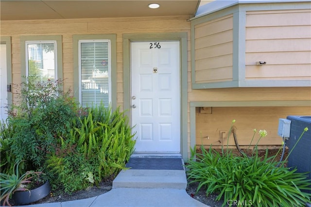 property entrance featuring central AC unit