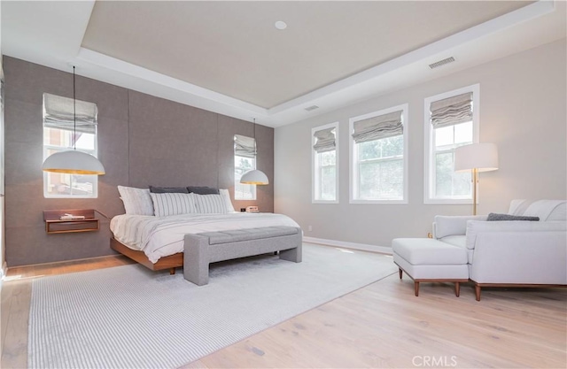 13 Goldenrod, Lake Forest, CA 92630 - bedroom featuring a raised ceiling, light wood-style flooring, and multiple windows