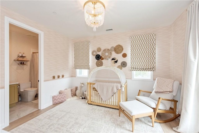 13 Goldenrod, Lake Forest, CA 92630 - bedroom with a chandelier, wallpapered walls, wood finished floors, and ensuite bathroom