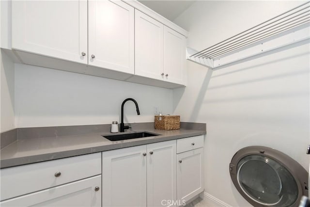 13 Goldenrod, Lake Forest, CA 92630 - laundry room featuring cabinet space and baseboards