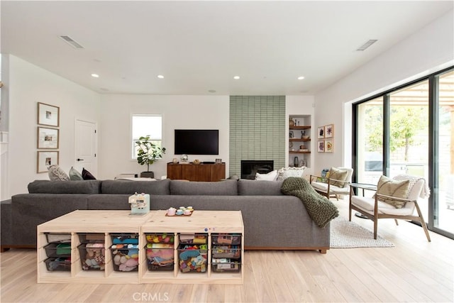 13 Goldenrod, Lake Forest, CA 92630 - living room with recessed lighting, a large fireplace, and light wood-style floors
