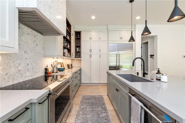 13 Goldenrod, Lake Forest, CA 92630 - kitchen featuring a sink, extractor fan, stainless steel appliances, light wood finished floors, and light countertops