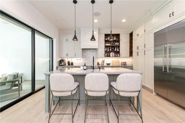 13 Goldenrod, Lake Forest, CA 92630 - kitchen featuring built in fridge, a sink, tasteful backsplash, light wood-style flooring, and open shelves