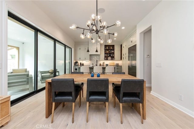 13 Goldenrod, Lake Forest, CA 92630 - dining area with a chandelier, light wood-style floors, and baseboards