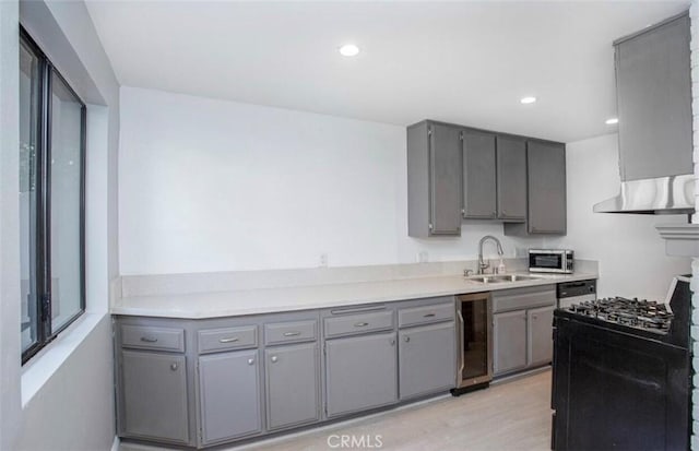 8641 Glenoaks Blvd Unit 107, Sun Valley, CA 91352 - kitchen with beverage cooler, a sink, gray cabinets, and light wood-style floors