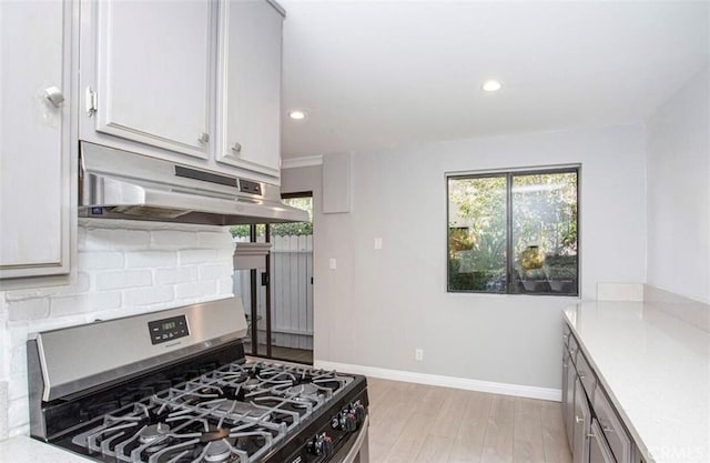 8641 Glenoaks Blvd Unit 107, Sun Valley, CA 91352 - kitchen with baseboards, stainless steel gas range, recessed lighting, under cabinet range hood, and backsplash