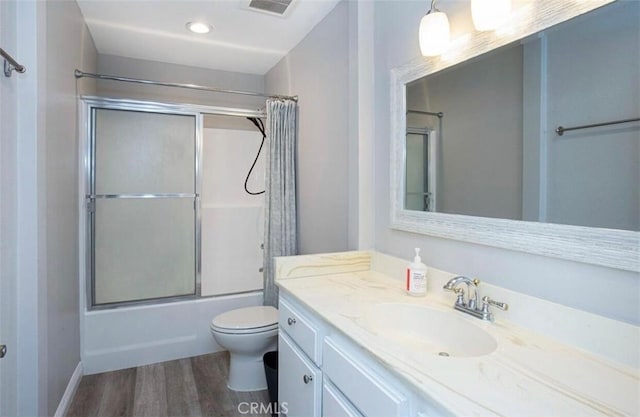 8641 Glenoaks Blvd Unit 107, Sun Valley, CA 91352 - full bath with vanity, visible vents, wood finished floors, toilet, and enclosed tub / shower combo