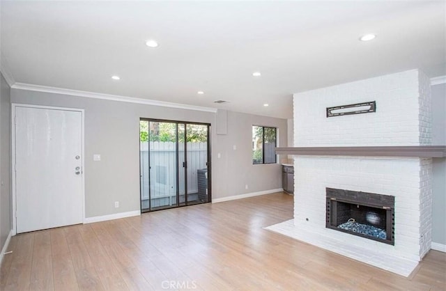 8641 Glenoaks Blvd Unit 107, Sun Valley, CA 91352 - unfurnished living room featuring crown molding, baseboards, a fireplace, and wood finished floors