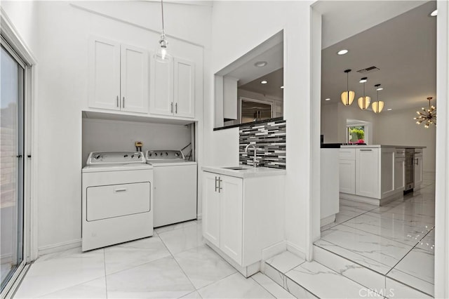 4250 Louise Ave, Encino, CA 91316 - washroom featuring visible vents, washing machine and dryer, cabinet space, a sink, and marble finish floor