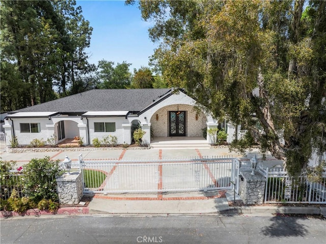 4250 Louise Ave, Encino, CA 91316 - single story home with french doors, stucco siding, a shingled roof, and a fenced front yard