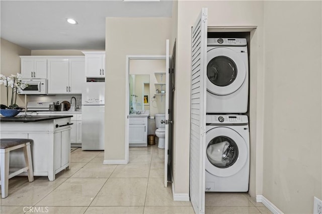 4250 Louise Ave, Encino, CA 91316 - laundry area featuring laundry area, stacked washer / drying machine, light tile patterned floors, baseboards, and recessed lighting