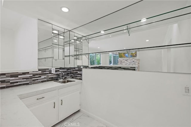 4250 Louise Ave, Encino, CA 91316 - interior space featuring decorative backsplash, marble finish floor, recessed lighting, white cabinetry, and a sink