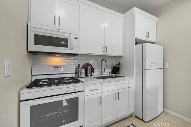 4250 Louise Ave, Encino, CA 91316 - kitchen featuring a sink, white appliances, light countertops, white cabinetry, and tasteful backsplash