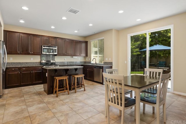 750 Arbor Glen Ln, Vista, CA 92081 - kitchen featuring a center island, appliances with stainless steel finishes, a wealth of natural light, and a kitchen bar