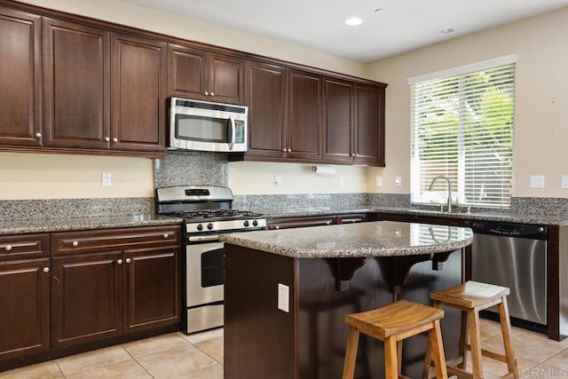 750 Arbor Glen Ln, Vista, CA 92081 - kitchen featuring a sink, appliances with stainless steel finishes, a breakfast bar area, and light tile patterned flooring