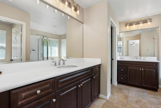 750 Arbor Glen Ln, Vista, CA 92081 - full bath with baseboards, visible vents, two vanities, and a sink