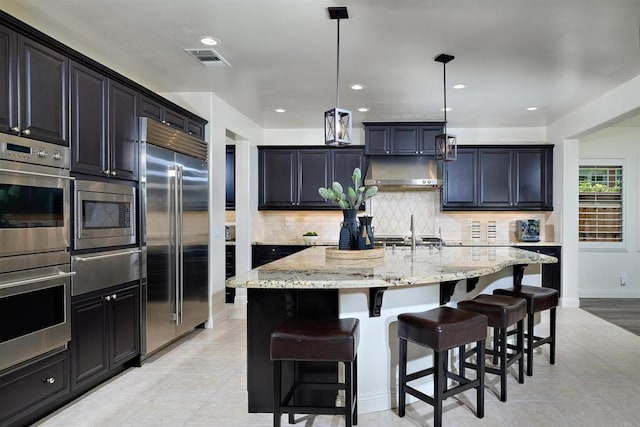 6981 Corte Langosta, Carlsbad, CA 92009 - kitchen featuring built in appliances, a warming drawer, light tile patterned floors, light stone countertops, and recessed lighting