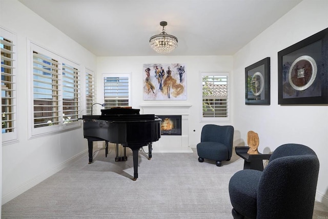 6981 Corte Langosta, Carlsbad, CA 92009 - living area with carpet floors, a chandelier, a glass covered fireplace, and baseboards