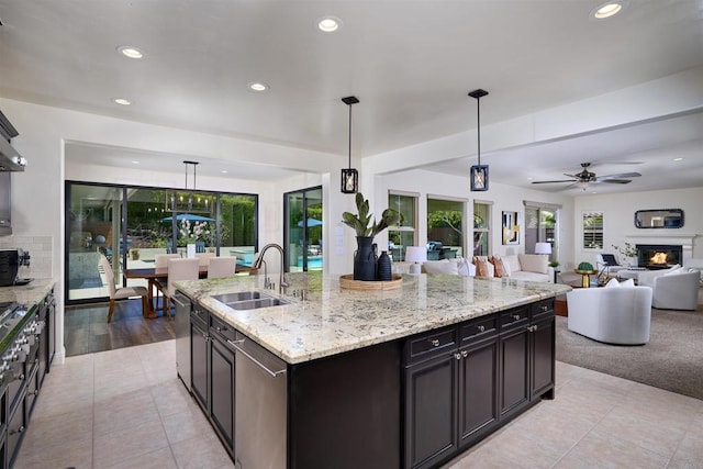 6981 Corte Langosta, Carlsbad, CA 92009 - kitchen with a sink, recessed lighting, open floor plan, decorative light fixtures, and light stone counters