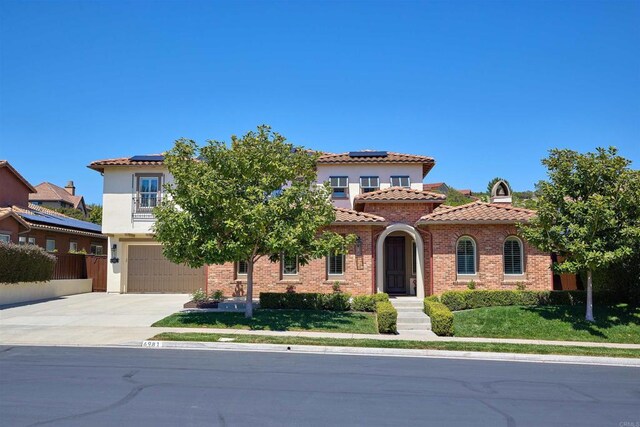 6981 Corte Langosta, Carlsbad, CA 92009 - mediterranean / spanish-style house with solar panels, concrete driveway, a garage, and a tile roof