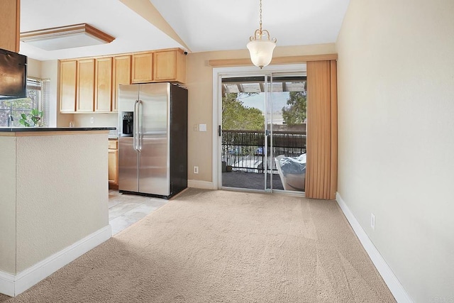kitchen with decorative light fixtures, stainless steel refrigerator with ice dispenser, baseboards, and light colored carpet