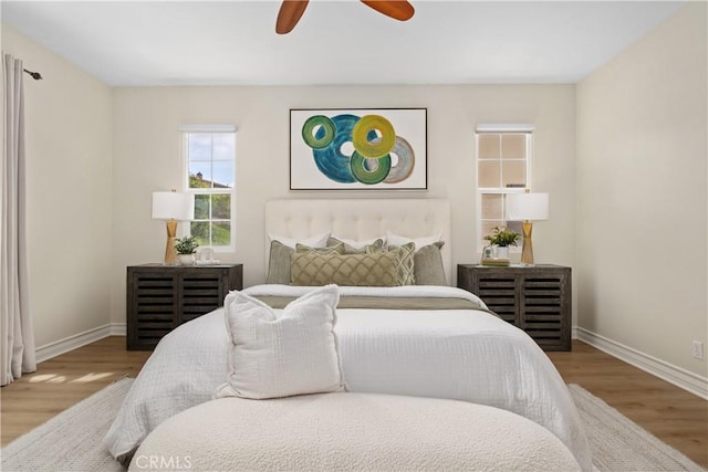 bedroom with baseboards, a ceiling fan, and wood finished floors