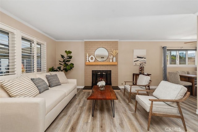 18401 Goodwin Ln, Huntington Beach, CA 92646 - living room featuring light wood-style floors, a brick fireplace, crown molding, and baseboards