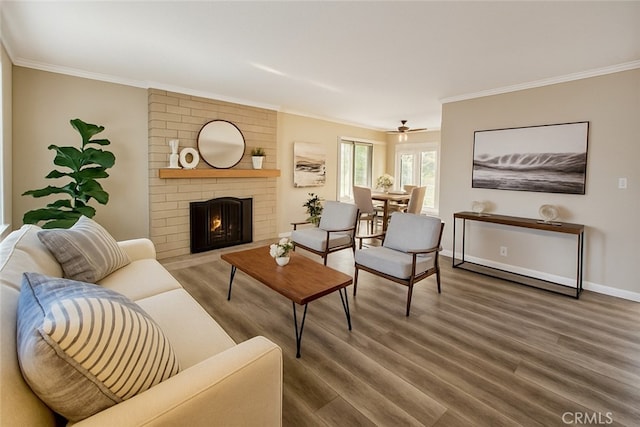 18401 Goodwin Ln, Huntington Beach, CA 92646 - living room featuring a brick fireplace, baseboards, ornamental molding, and wood finished floors