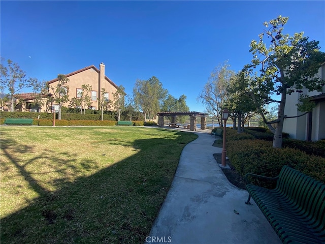 view of property's community with a lawn and a gazebo