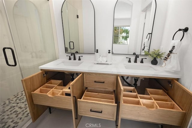 bathroom with a stall shower, double vanity, and tile patterned flooring