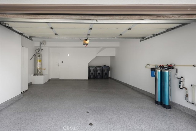 garage featuring water heater, a garage door opener, and baseboards